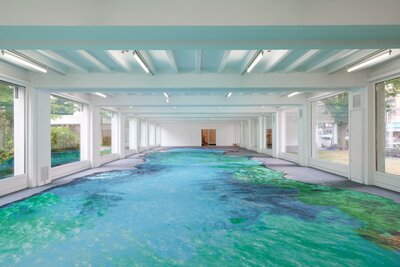 A very large painting covers almost the entire floor of the hall